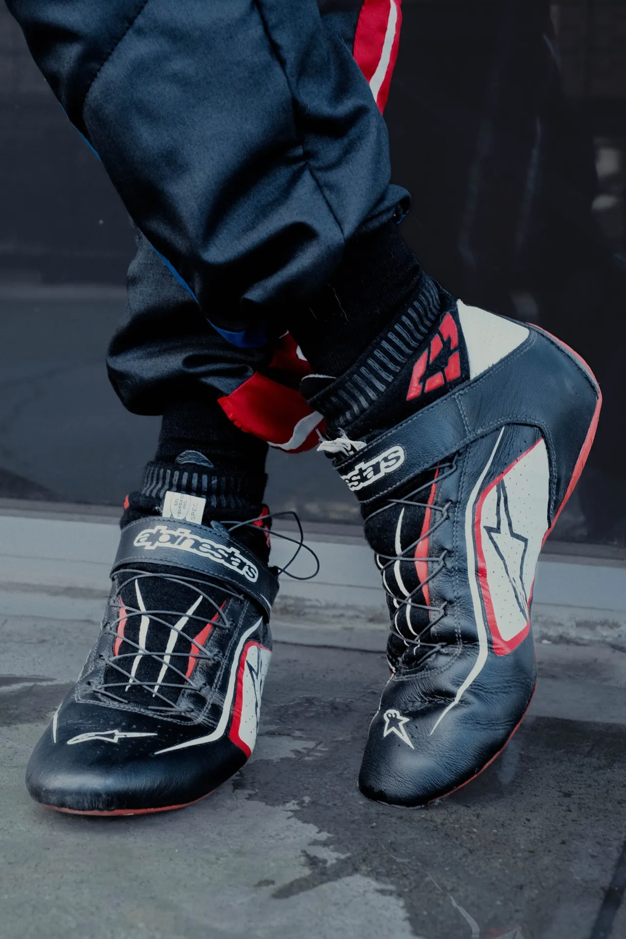Alpinestars racing boots, laced and ready on pit lane.
