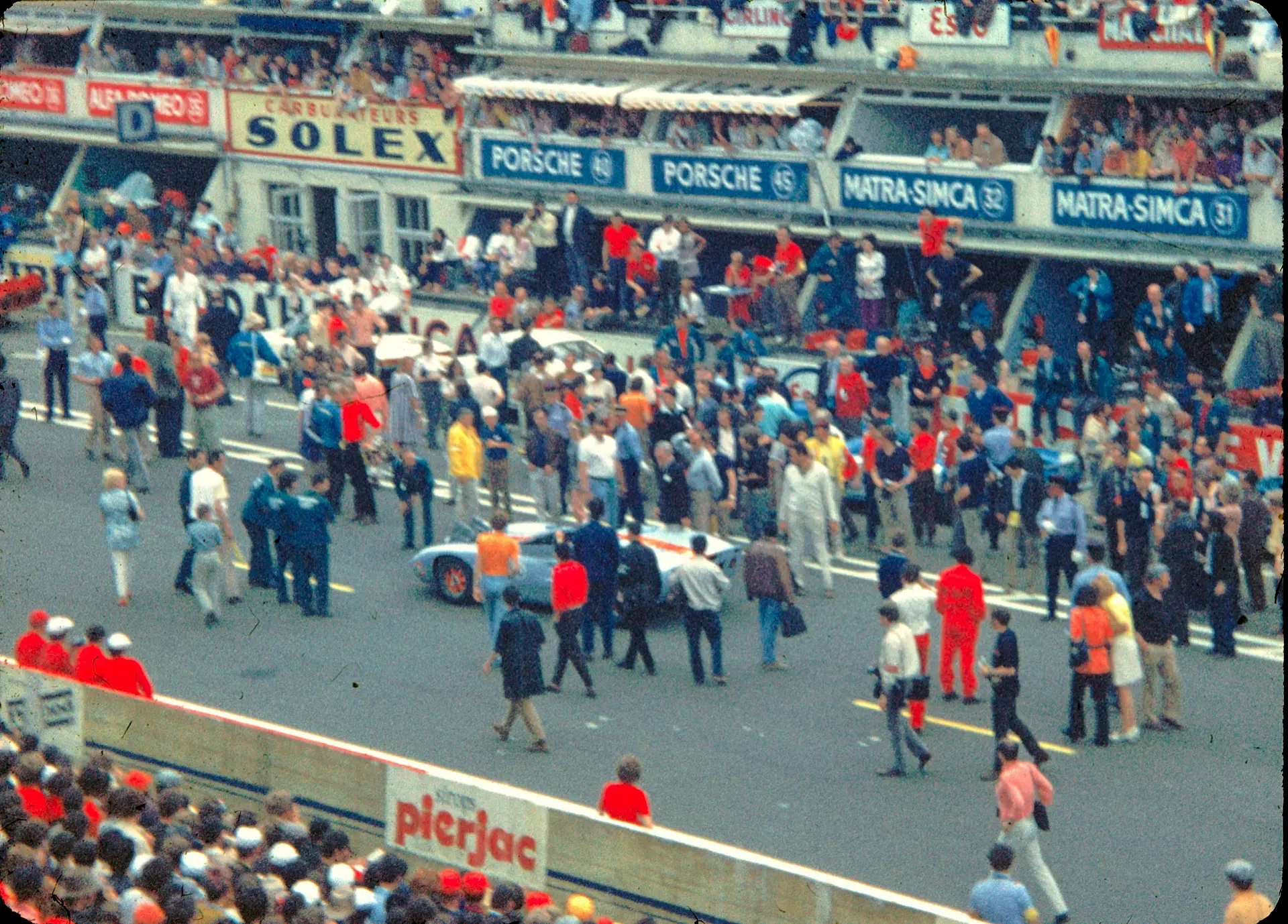 The filming of the motion picture 'Le Mans' in 1970, cars and crew on the pit straight.