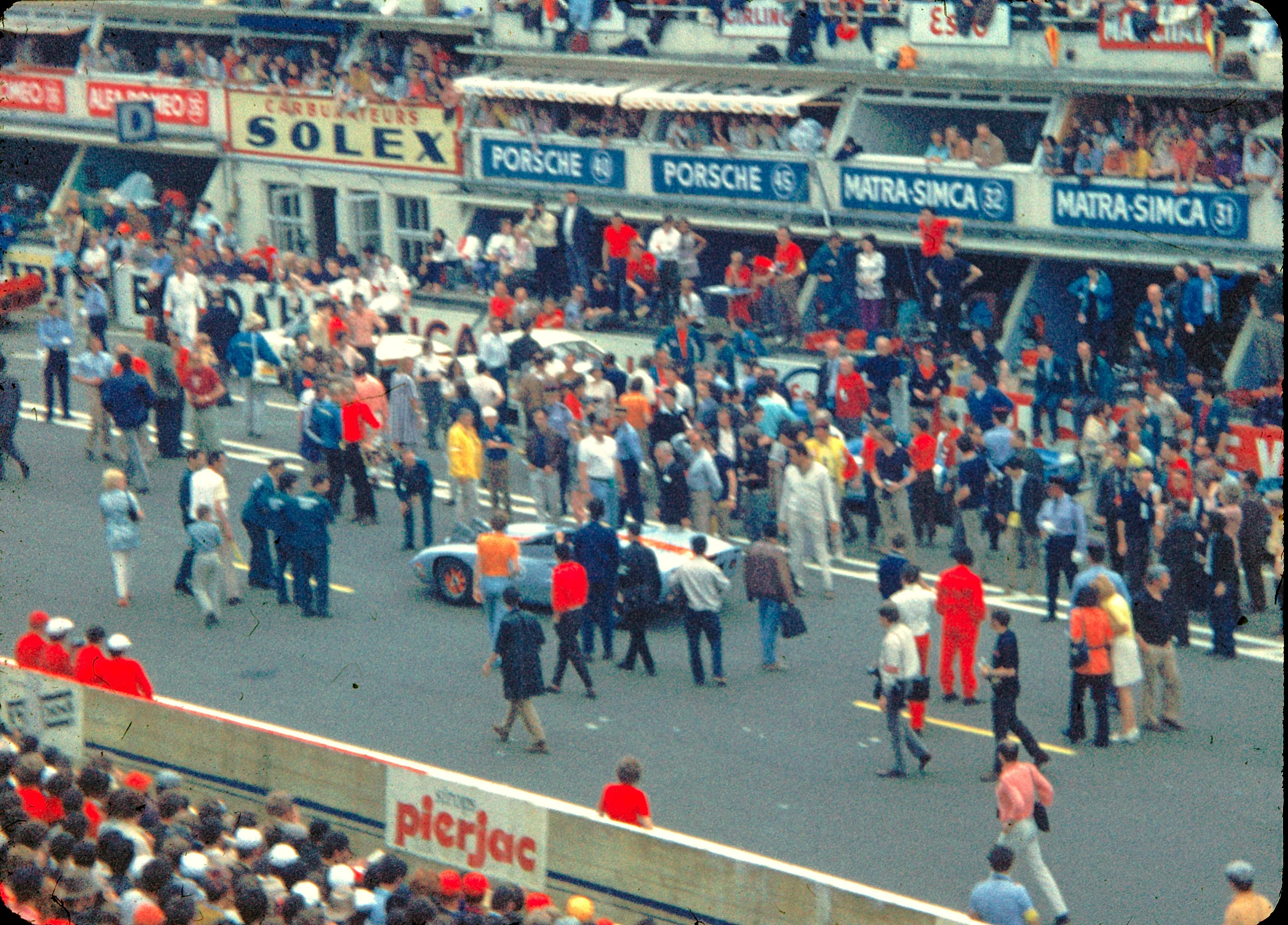 The filming of the motion picture 'Le Mans' in 1970, cars and crew on the pit straight.