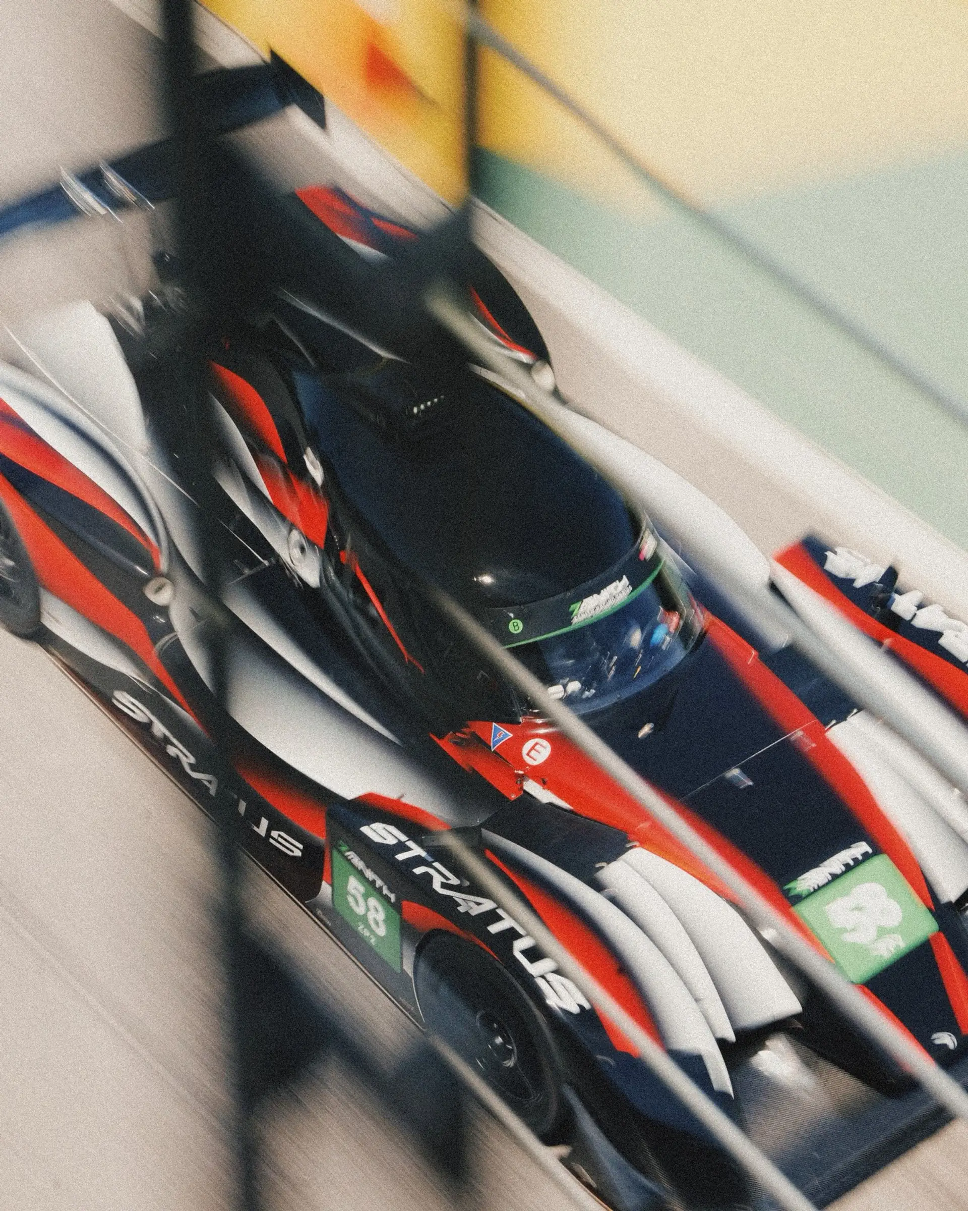 A Stratus prototype in a hard panning blur, the bodywork streaked by speed at VIR.