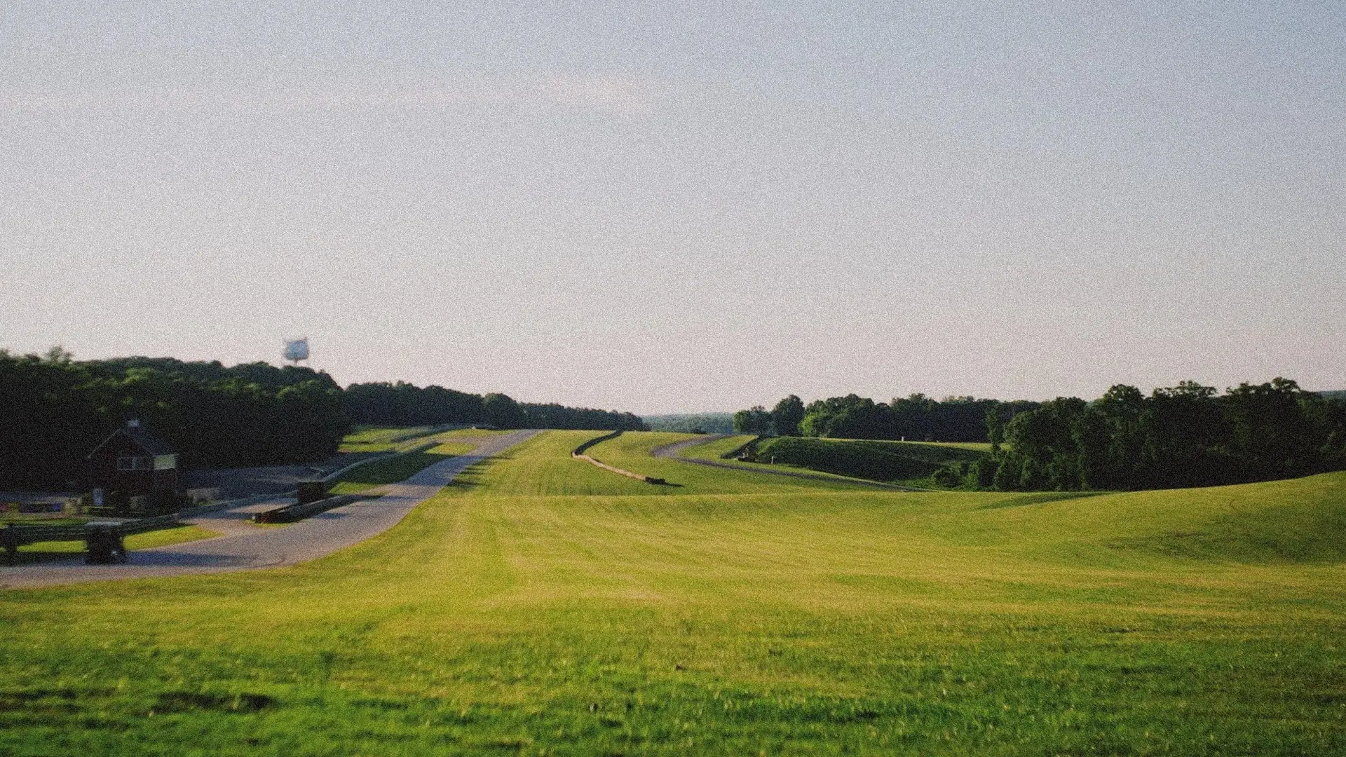 The green hills of VIR in low summer light, the circuit threading away through the trees toward the horizon.
